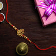 Golden Finish Ganesh Ji Rakhi With Red Thread - Rakhi | Desimart